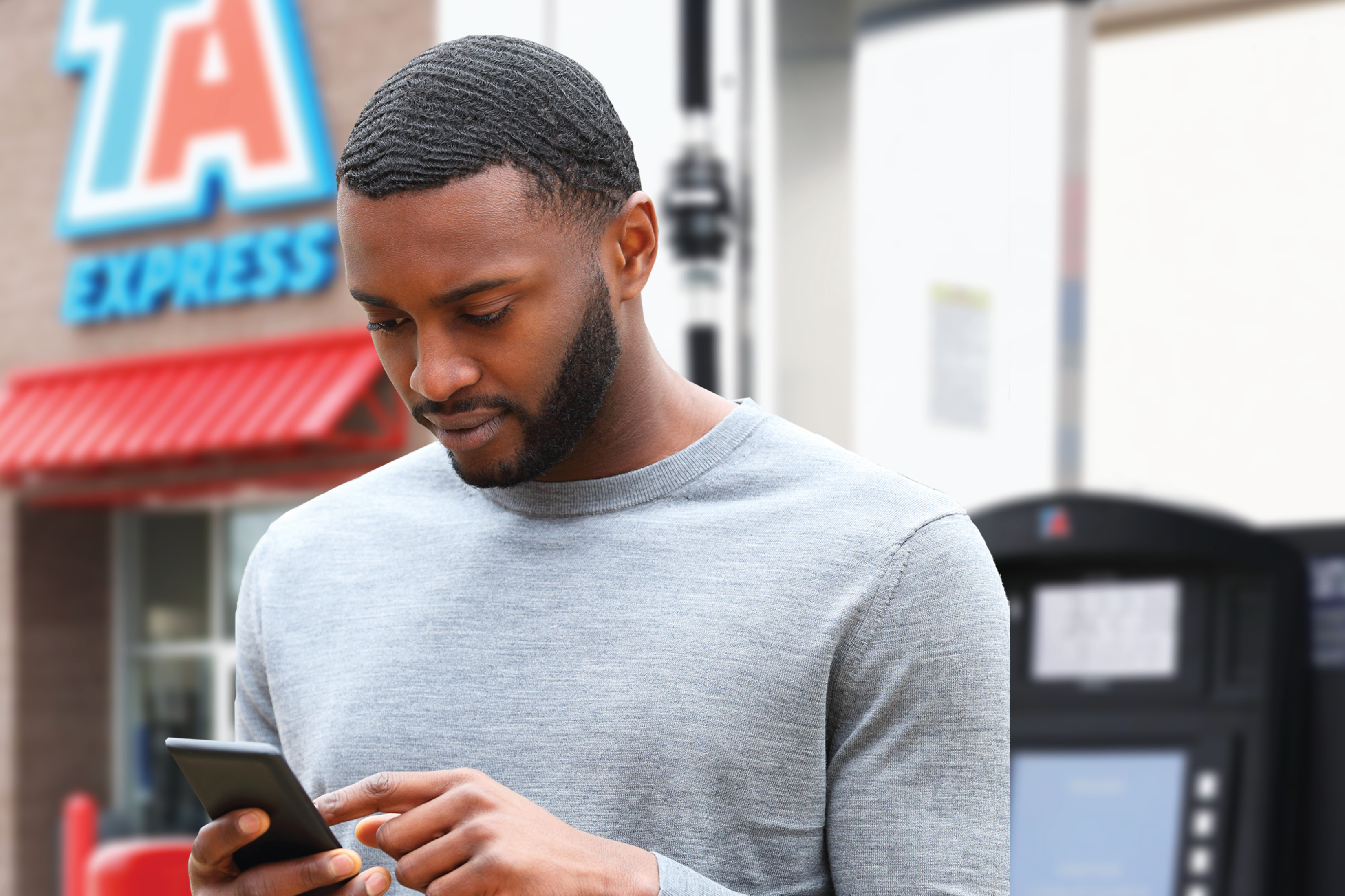 Professional driver using the TruckSmart app to track UltraONE loyalty program account activity