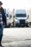 woman in front of trucks