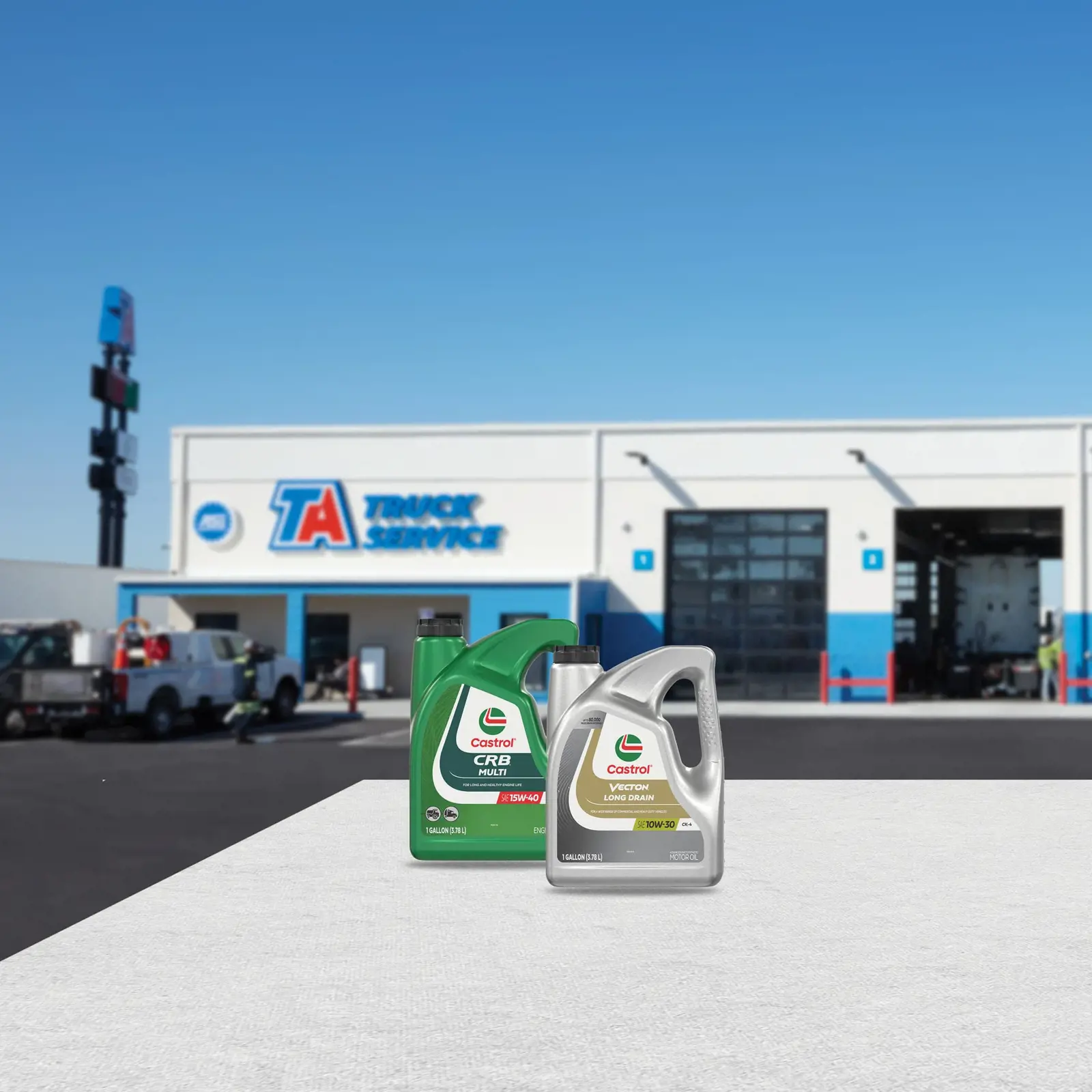 Castrol CRB Multi Oil and Castrol Vecton Oil in front of a TA Truck Service facility